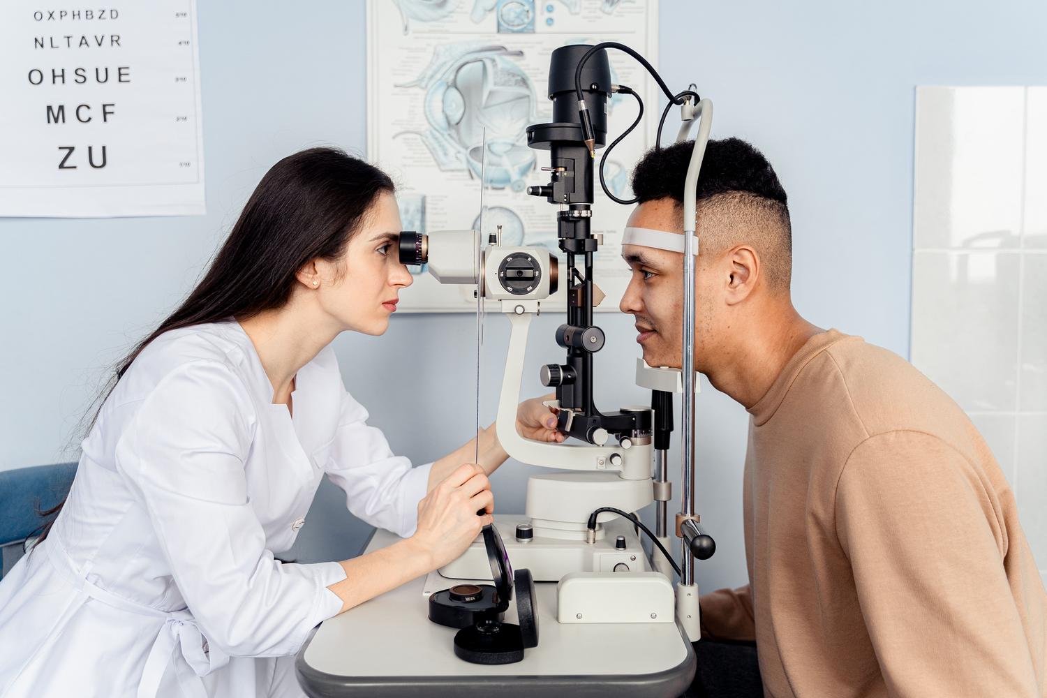 Examen oftalmológico profesional realizado por un optometrista utilizando equipo moderno con un paciente.